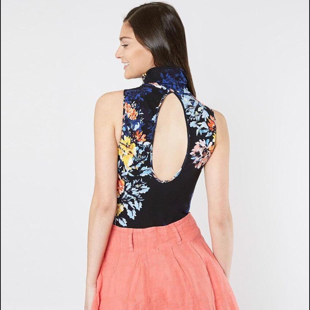 NWT. Free people pick floral body suit .